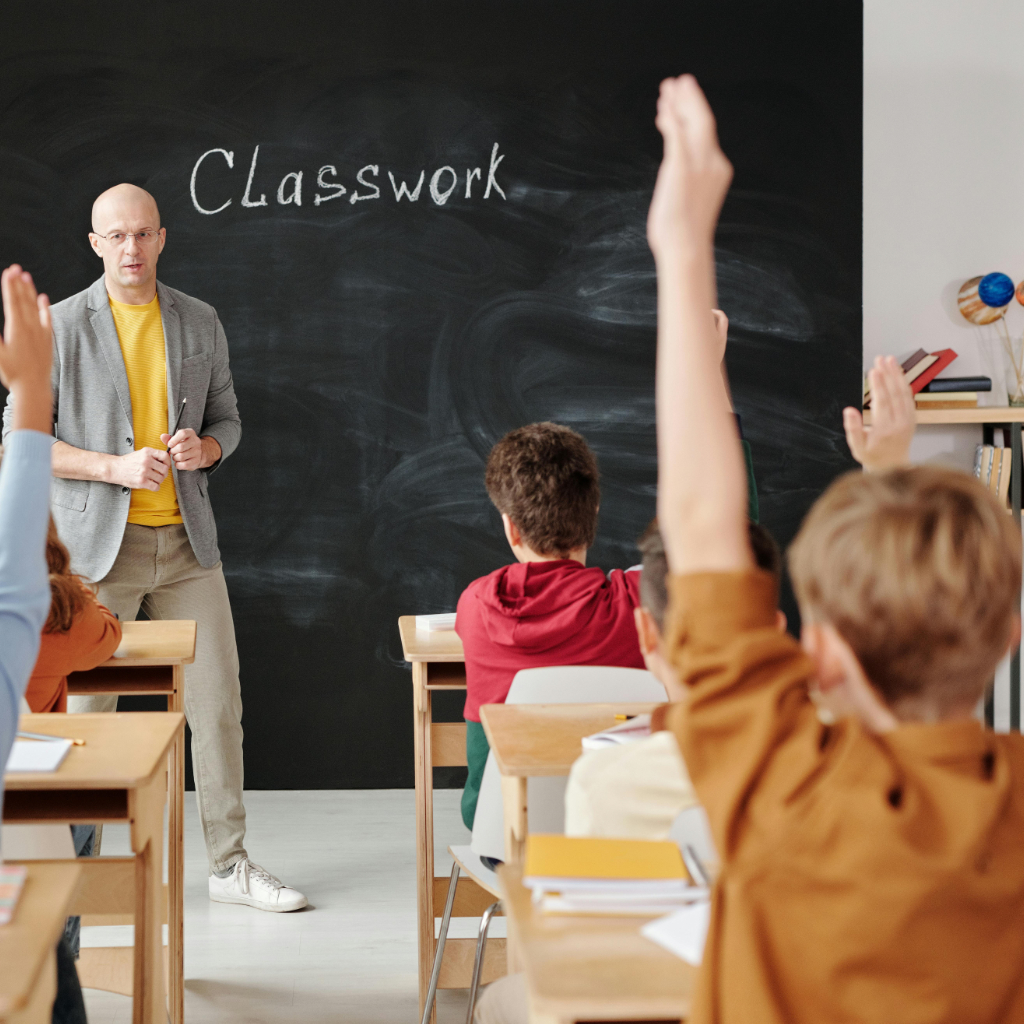 A teacher in front of a classroom of students.